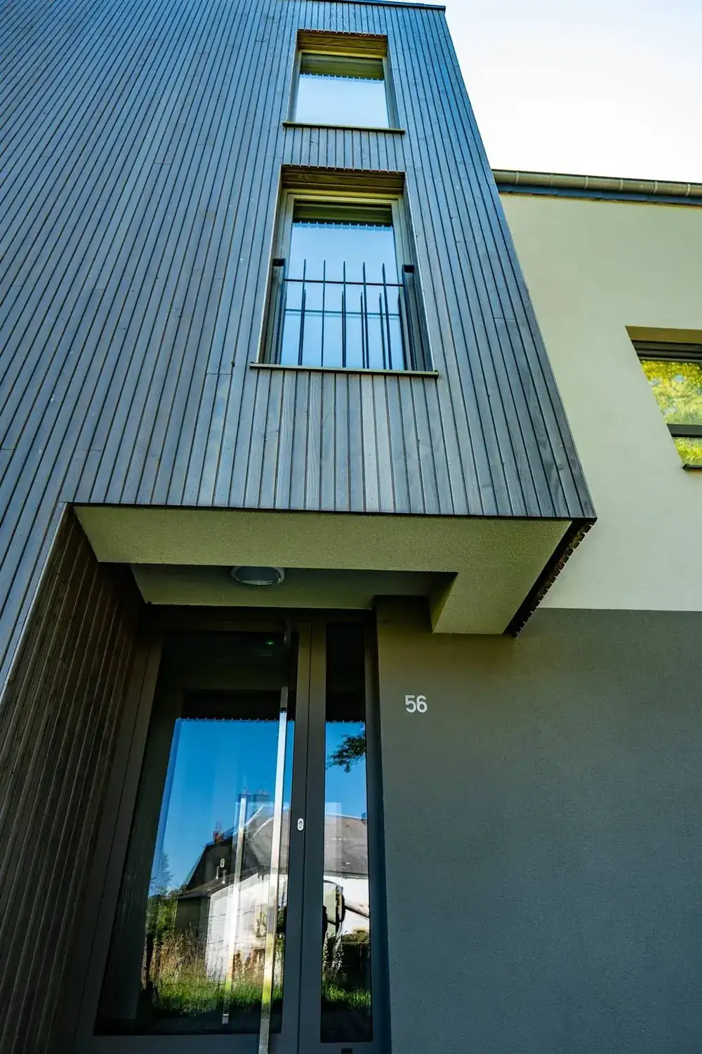 14 appartements à Habay — bardage bois et porte d'entrée en contre-plongée